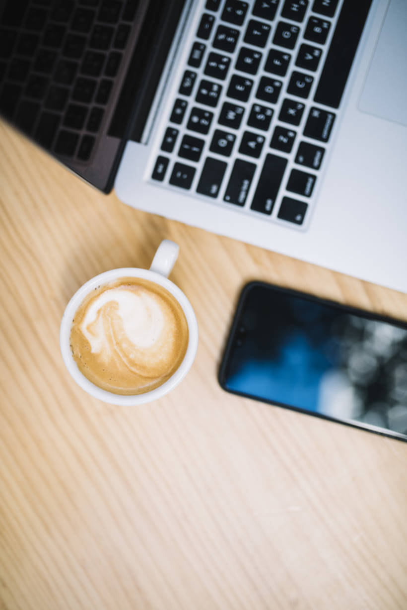 kopje-koffie-in-de-buurt-van-mobiele-telefoon-en-laptop-aan-tafel_23-2148068436.jpg 